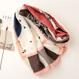 Detailed view of the artistic geometric print and soft texture of the long shawl scarf