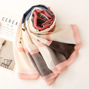 Detail of multi-color cotton-linen scarf with small heart patterns and smooth stitched edges