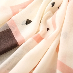 Detailed macro view of the soft cotton-linen fabric texture with heart and geometric patterns