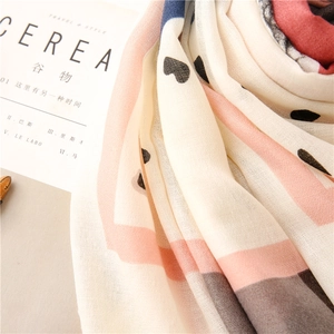 Detail of soft linen shawl with printed black hearts and geometric color block patterns