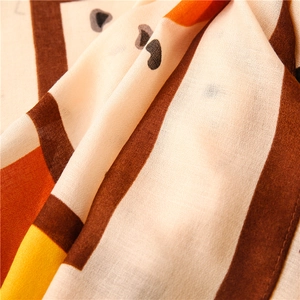 Macro detail of lightweight leopard print scarf featuring geometric color blocks and mesh