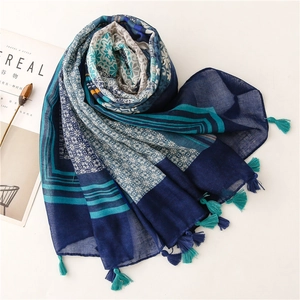 Detail of bohemian printed scarf with navy and turquoise patterns and fringed tassels