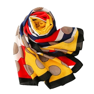 Fashionable geometric print scarf in vibrant red and yellow, stylish beach sun shawl