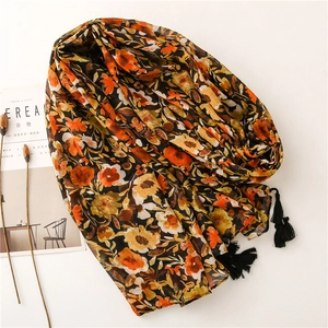 Floral print cotton linen scarf with black tassels displayed on a minimal background