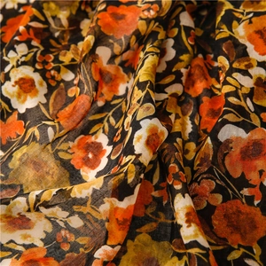 Detail of vibrant floral print on lightweight black linen-feel fabric with soft texture