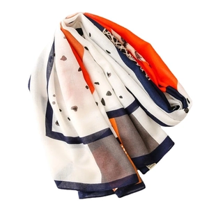 Lightweight cotton linen shawl featuring orange and navy blue geometric print pattern