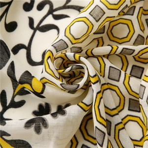 Detailed close-up of floral and geometric print on soft cotton linen scarf fabric