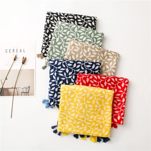 Detailed view of soft linen scarves featuring leaf prints and elegant tassels in six colors