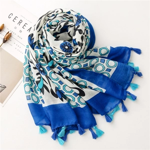 Detail of royal blue floral cotton linen scarf with geometric patterns and fringe