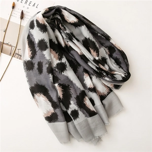 Fashionable leopard print cotton scarf in grey and beige with soft frayed edges