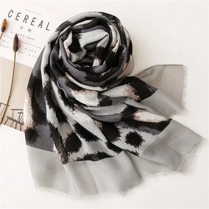 Detailed view of lightweight leopard print scarf with soft fringe edges and cotton linen texture