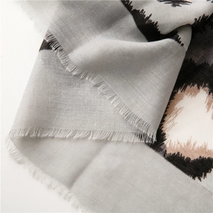 Detailed view of leopard print cotton linen scarf with soft eyelash fringe edges