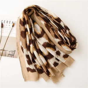 Chic cotton linen scarf with abstract leopard print and fringes on a white background
