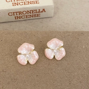 Elegant pink enamel flower stud earrings with pearl centers and gold plating
