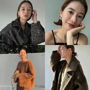 Detail of chunky C-shape irregular earrings and minimalist rings styled with autumn outfits