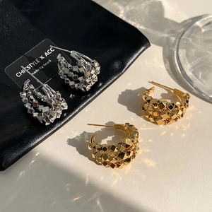 Minimalist silver and gold geometric C-shaped earrings with stacked metallic facets