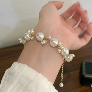Elegant pearl bracelet with gold metal accents and adjustable chain for women