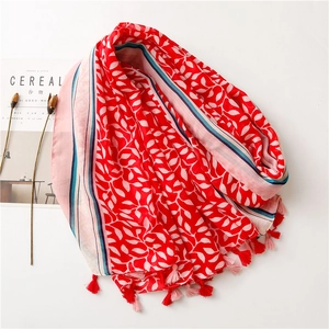 Detailed close-up of red grape leaf pattern linen scarf with colorful tassel fringes