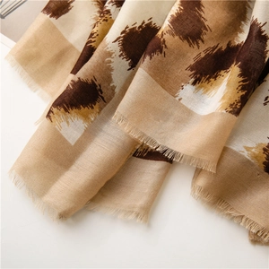 Close-up of leopard print cotton linen scarf with soft texture and long fringe tassels