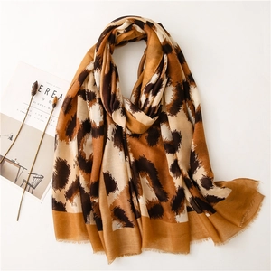 Detail of cotton linen scarf with brown leopard print and fine fringe edges