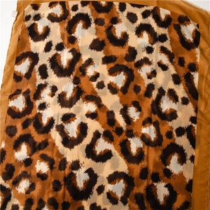 Detail of leopard print scarf with soft brown and black animal pattern texture