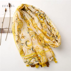 Detail of bohemian paisley print cotton linen scarf with yellow tassel edge trim