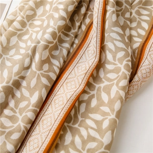 Detail of soft cotton linen scarf showing grape leaf print and striped geometric borders