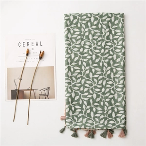 Close-up of soft cotton linen scarf with grape leaf pattern and colorful tassels