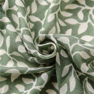 Macro detail of breathable cotton linen scarf fabric with leaf print and soft texture