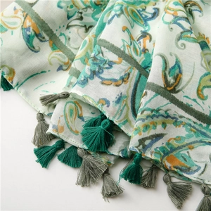 Macro shot of paisley pattern cotton linen scarf with soft fringe tassels detailing