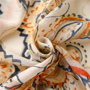 Close-up of bohemian paisley cotton linen scarf with soft fringe and silk texture