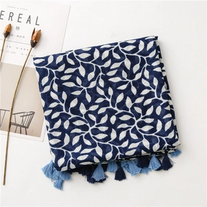 Detail of navy cotton linen scarf with white grape leaf pattern and fringe trim
