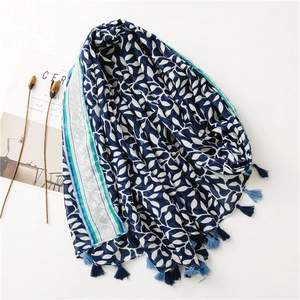 Close-up of soft blue cotton scarf with grape leaf print and delicate fringe details