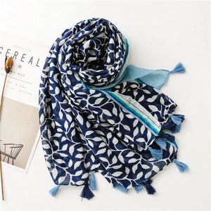 Detail of soft grape leaf print scarf with tassels on white minimalist background