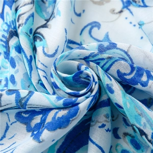 Detailed view of lightweight cotton-linen scarf with blue paisley and floral print texture
