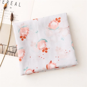 Close-up of soft cotton scarf with pink and orange Protea floral prints on white base