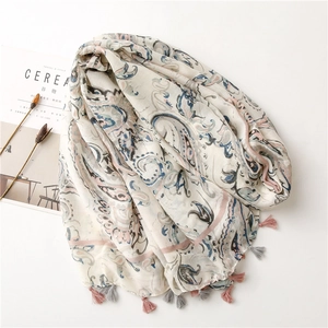 Detail of lightweight cotton linen scarf showing paisley prints and pink fringe tassels