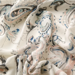 Close-up of soft linen scarf with delicate paisley pattern and natural draped texture