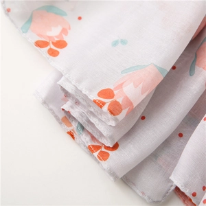 Detailed close-up of breathable linen floral scarf with delicate stitching and pink print