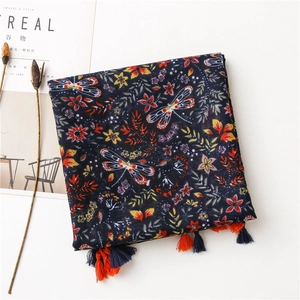 Detailed view of bohemian floral cotton linen scarf with tassels and dragonfly print