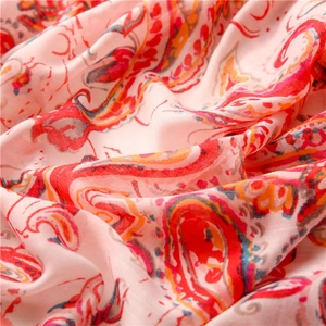 Macro view of paisley patterns on soft pink cotton linen scarf with fiber texture detail