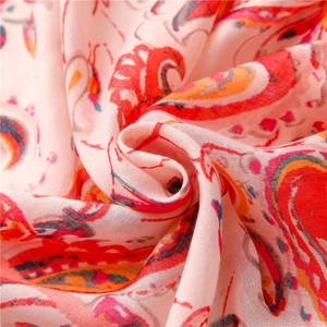 Detailed texture of pink paisley cotton-linen scarf showing soft draped fabric