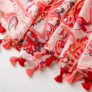 Close-up of pink paisley linen scarf showing retro floral prints and tassel fringe details