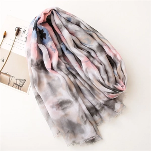 Detail of colorful watercolor abstract print scarf with soft fringe edges and light texture