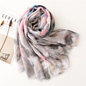 Detail of artistic watercolor print scarf showing soft texture and natural fringe edges