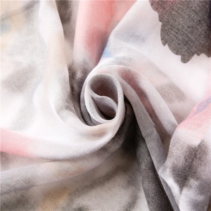 Macro shot of thin floral printed scarf fabric showing soft color dye and weave texture