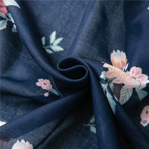 Detailed close-up of navy blue floral fabric with soft pink and yellow blossom prints