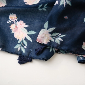 Detail of navy blue floral scarf with delicate fringe and cotton-linen texture