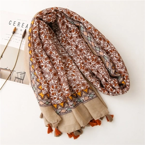 Detail of floral linen scarf with tassels and geometric patterns for beach sun protection