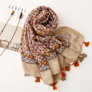 Detailed view of floral cotton linen scarf with bohemian fringe and soft fabric texture